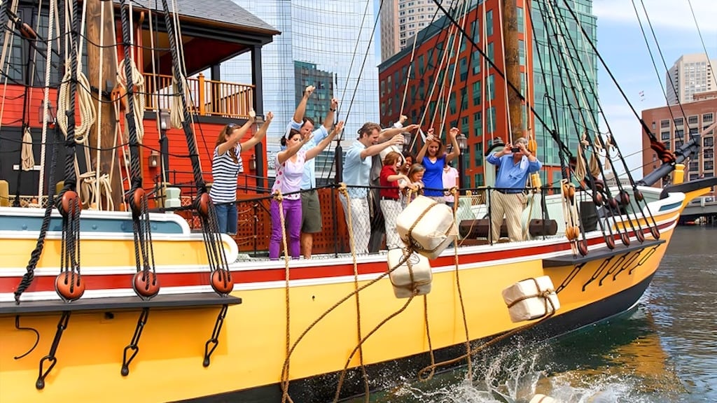 Actors tossing tea crates overboard from an 18th-century replica ship