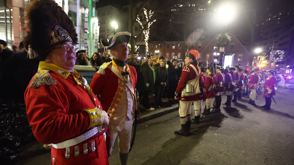 Evening harbor scene with lanterns and period musicians at the reenactment