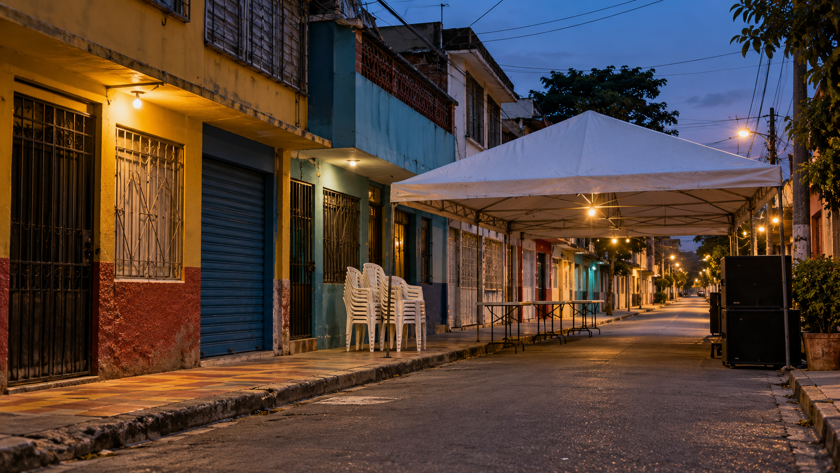 A quiet Barrio Obrero street with a canopy set up for a neighborhood music gathering.