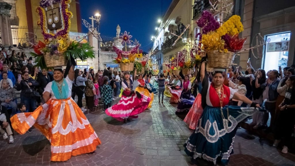 The ornate façade of Teatro Juárez illuminated in vibrant colors during an evening performance at Festival Internacional Cervantino.